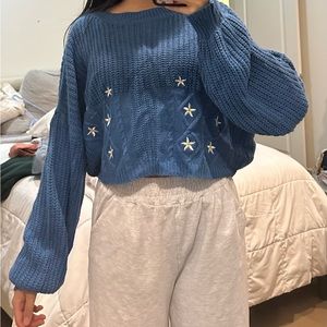 Brand not listed on tag, size M but fits size S. Cute blue sweater w/ flowers.